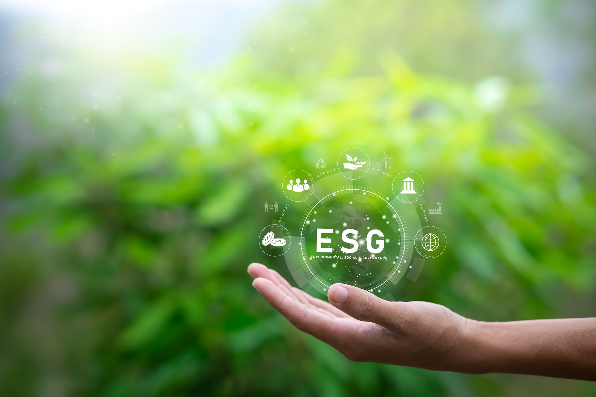 ESG icon concept in the hand of human for environmental, social, and governance in sustainable and ethical business on the network connection on nature background.