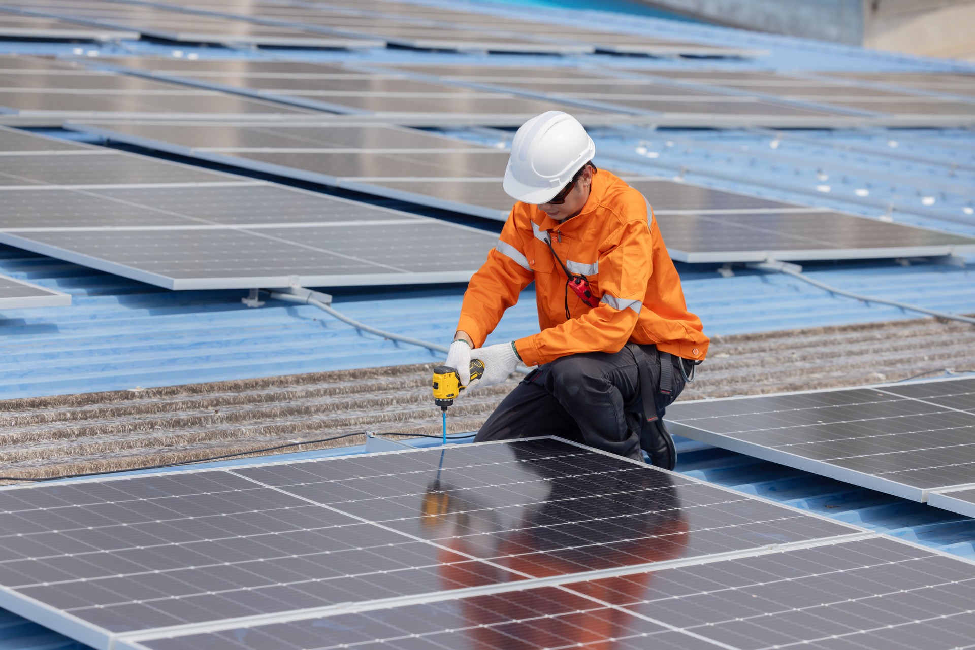 Engineer repair solar panel on the factory rooftop