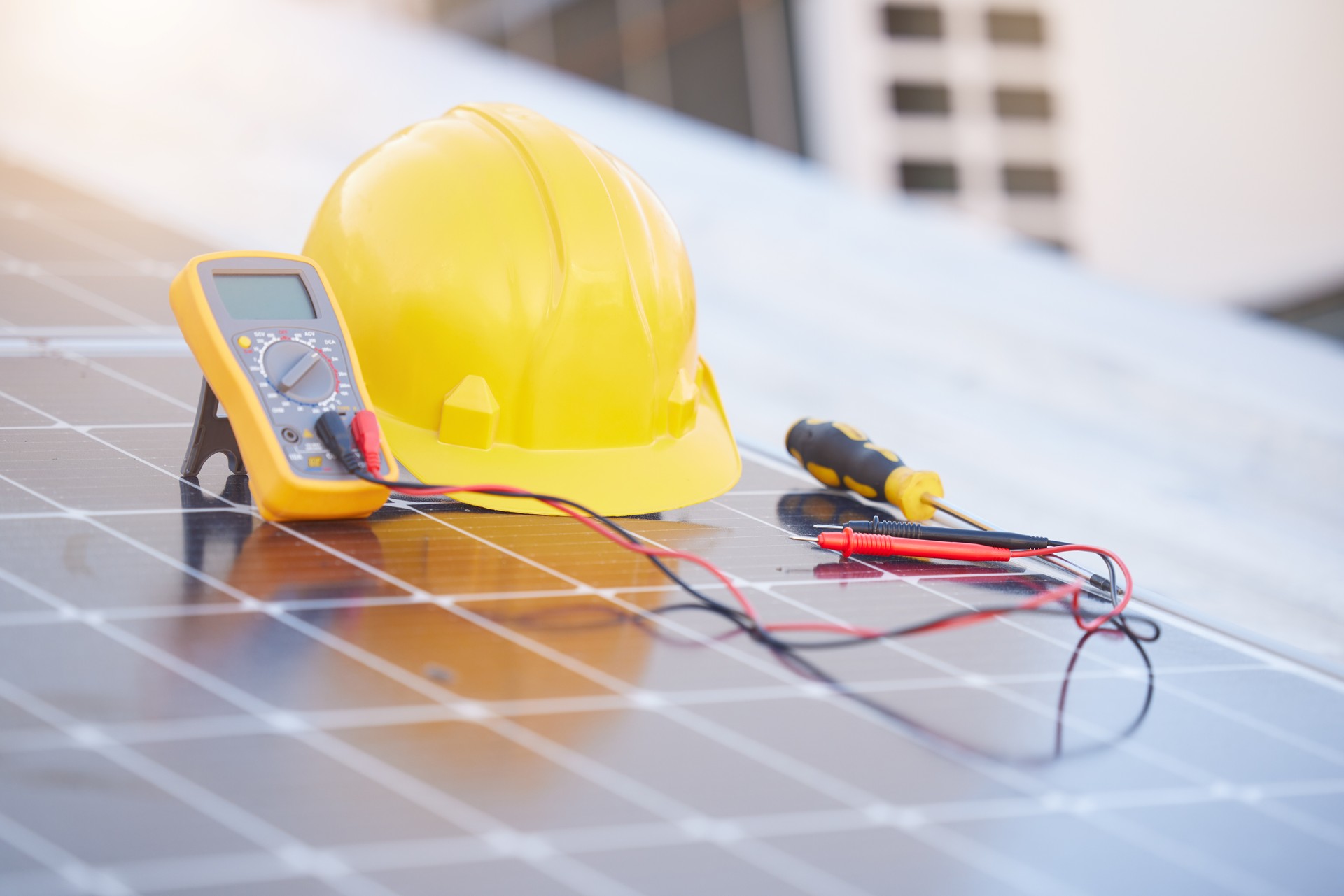 Tools, solar panels or helmet on roof for solar energy installation in a city development project. Voltmeter, Construction, renewable energy or electric engineering equipment for building maintenance